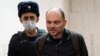 FILE - Russian opposition activist Vladimir Kara-Murza is escorted to a hearing in a court in Moscow, Feb. 8, 2023. 