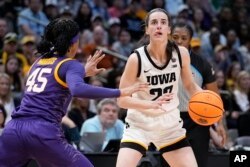 Iowa's Caitlin Clark looks to shoot past LSU's Alexis Morris during the second half of the NCAA Women's Final Four championship basketball game, April 2, 2023, in Dallas.