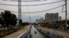 FILE - A homeless Chilean man collects items from the El Zanjón de la Aguada water canal in hopes of reselling them in Santiago, Chile, May 15, 2024. 