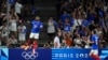 France's Alexandre Lacazette, left, celebrates after scoring his side's first goal during the men's Group A soccer match between France and the United States at the Velodrome stadium, July 24, 2024, in Marseille, France.