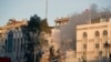 Emergency services work at a destroyed building hit by an airstrike in Damascus, Syria, April 1, 2024. 