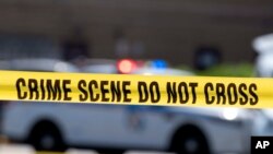 FILE - Crime tape blocks off a crime scene in Baltimore, Maryland, July 13, 2021. On July 5, 2024, a U.S. Marshal shot an armed man during an attempted carjacking in Washington, near the home of U.S. Supreme Court Justice Sonia Sotomayor.