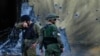 FILE - On Oct. 14, 2023, Israeli soldiers walk past houses destroyed by Hamas militants in Be'eri, Israel, in their Oct. 7 attack on southern Israel. The Israeli military on July 11, 2024, acknowledged errors in its response to the Hamas incursion.