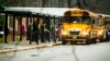 FILE - Students exit a school bus during the first day back to Richneck Elementary School on Jan. 30, 2023, in Newport News, Virginia, after a 6-year-old boy who shot his teacher.