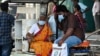 People wear face masks as they arrive at a government hospital in Chennai, India, on April 1, 2023, amid a rise in COVID-19 cases in India. 