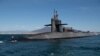 FILE - The guided missile submarine USS Florida conducts a brief stop in the Bay of Naples, Naples, Italy, March 16, 2023. 