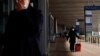 FILE - A traveler walks with a suitcase outside at a terminal hall, during the annual Spring Festival travel rush ahead of the Chinese Lunar New Year, in Beijing Capital International Airport, Beijing, China Jan. 18, 2023. 