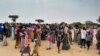 Sudanese people who fled violence in their country wait to be registered at a camp near the border between Sudan and Chad, April 26, 2023.