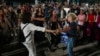People react as they hear the news of the release of 13 Israeli hostages held by Hamas in the Gaza strip, in Tel Aviv, Israel.