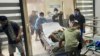 Patients at Manuel J. Santos Hospital in Butuan City, southern Philippines, are evacuated after an earthquake, Dec. 2, 2023.