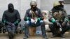 Pro-Russia armed men sit near police headquarters in Slovyansk April 13, 2014.