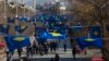 FILE - Kosovo's flags fly in Pristina as police officers patrol during a celebration of the country's independence, Feb. 17, 2020.