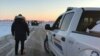 FILE - This photo released Jan. 20, 2022, by the Royal Canadian Mounted Police in Emerson, Manitoba, shows RCMP officers near the Canada-US border. Canada and the U.S. have agreed to trace guns that are intercepted at the border. (RCMP/AFP)