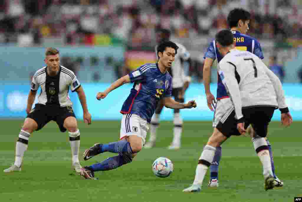 Milieu #15 ya Dachi Kamada ya Japon na ndembo kati na basani basato ba Allemagne na match ya gorupe E ya Mondial Qatar 2022 na stade Khalifa, Doha, 23 novembre 2022. (Photo Adrian DENNIS / AFP)