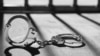 Handcuff and prison bars