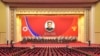 Foto dari pemimpin Korea Utara Kim Jong Un dipasang dalam pertemuan nasional untuk memperingati 10 tahun menjabatnya Kim sebagai pemimpin partai berkuasa di Korea Utara, Partai Pekerja Korea (WPK), di Pyongyang, pada 10 April 2022. (Foto: KCNA via Reuters)