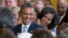 FILE - President Barack Obama and first lady Michelle Obama applaud during the portrait unveiling ceremony for former President George W. Bush and former first lady Laura Bush portraits, May 31, 2012, at the White House in Washington. 