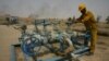 (File) An Iraqi worker checks the valves at the Kirkuk oil field on June 29, 2009, 225 kms from the capital Baghdad.
