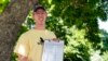 FILE - Nate Golden, president of the Maryland Child Alliance, poses for a portrait with a petition form for the Baltimore Baby Fund, July 3, 2024, in Baltimore. 