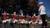 FILE - A woman looks at memorials along a bike path to remember the victims of the October 31 attack, in New York City, Nov. 3, 2017.