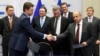 Russian Energy Minister Alexander Novak shakes hands with Ukraine's Energy Minister Yuri Prodan (R) after gas talks between the European Union, Russia and Ukraine at the European Commission headquarters in Brussels, Oct. 30, 2014. 