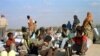 FILE - Somali refugees wait for a plane to take them home from Dabaab refugee camp in northern Kenya.