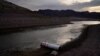 A buoy once used to warn of a submerged rock rests on the ground along the waterline near a closed boat ramp on Lake Mead at the Lake Mead National Recreation Area, Aug. 13, 2021, near Boulder City, Nev.