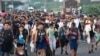 Migrants walk along the highway through Suchiate, Chiapas state in southern Mexico, July 21, 2024, during their journey north toward the U.S. border.