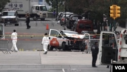 FILE - Investigators work around the wreckage of a pickup truck that alleged terror suspect Sayfullo Saipov used to mow down people on a bike path in New York City, Nov. 1, 2017. 