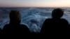 FILE - Rescued migrants look out to sea on the Geo Barents rescue ship, operated by Medecins Sans Frontieres (Doctors Without Borders), as the ship makes its way to the Italian port of Bari, in the central Mediterranean Sea, March 25, 2023.