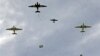 WWII-era Dakotas drop paratroopers near Normandy village of Ecausseville, western France, June 7, 2014.