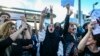 FILE - People shout slogans during a protest against the death of Iranian Mahsa Amini, in Istanbul, Turkey, Oct. 2, 2022. 