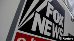 FILE - A Fox News channel sign is seen on a television vehicle outside the News Corporation building in New York City, Nov. 8, 2017. 