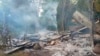 FILE - Smoke rises from debris and corrugated roofing of a school building that was burned to the ground in Taung Myint village in the Magway region of Myanmar on Oct. 16, 2022.