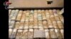 Seized money is displayed in an unknown location following an operation of the Carabinieri del Ros and the Provincial Command of Reggio Calabria in Italy and in various foreign countries in this still photo released today May 3, 2023. 