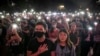 FILE - Para pengunjuk rasa mengangkat ponsel mereka tinggi-tinggi sambil menyanyikan "Glory to Hong Kong" dalam unjuk rasa di Chater Garden di Hong Kong, 26 Oktober 2019.