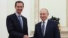 In this pool photograph distributed by the Russian state agency Sputnik on July 25, 2024, Russia's President Vladimir Putin, right, shakes hands with Syria's President Bashar al-Assad during their meeting at the Kremlin in Moscow on July 24, 2024.