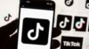 The TikTok logo is seen on a cellphone on Oct. 14, 2022, in Boston. A U.S. Commerce Department official describes TikTok as a threat.