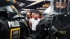 FILE -England fans speak with police officers as they celebrate ahead of a semi final match between Netherlands and England at the Euro 2024 soccer tournament in Dortmund, Germany, July 10, 2024. 