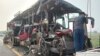 A roadside assistance worker tows away the mangled remains of a double-decker passenger bus that collided with a milk truck, near Unnao, in northern India state of Uttar Pradesh, July 10, 2024. 