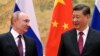 FILE - Chinese President Xi Jinping, right, and Russian President Vladimir Putin talk to each other during their meeting in Beijing, China on Feb. 4, 2022.