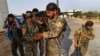 FILE - In this June 22, 2017, photo, U.S.-backed Syrian Democratic Forces (SDF) fighters, prepare for battle against Islamic State group militants, in Raqqa, northeast Syria. 