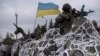 Ukrainian military vehicles drives toward Debaltseve on the outskirts of Artemivsk, eastern Ukraine, Feb. 8, 2015. 